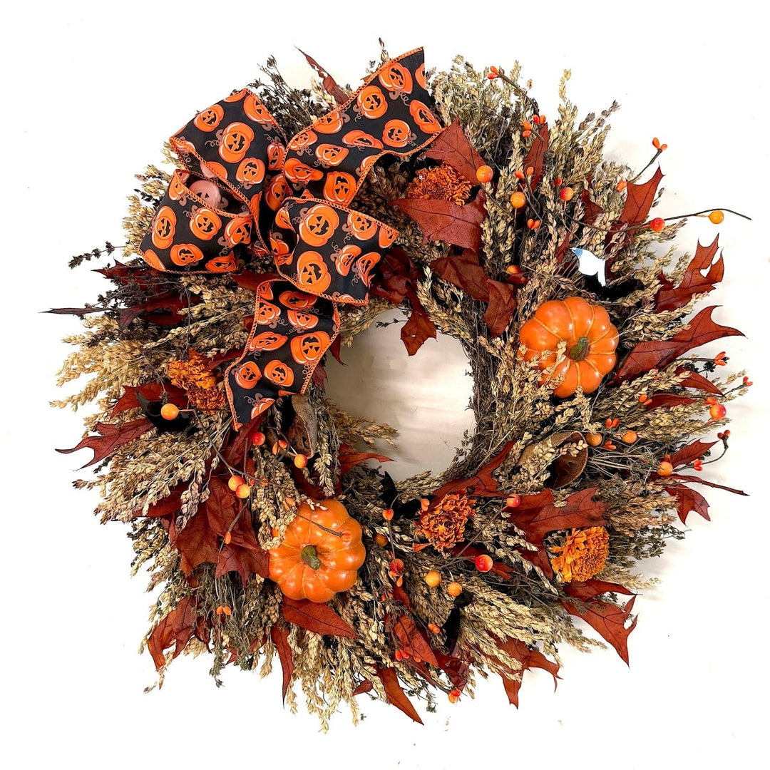 Festive Halloween Wreath - Creekside Farms Halloween wreath made with pumpkins, orange and black berries, fall leaves and finished with a bold Halloween ribbon 22"