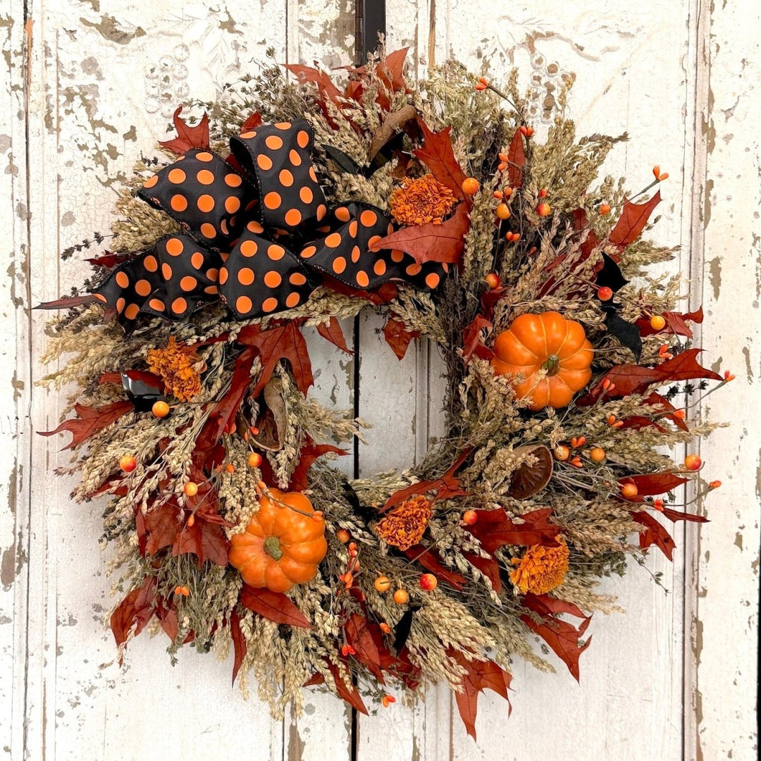 Festive Halloween Wreath - Creekside Farms Halloween wreath made with pumpkins, orange and black berries, fall leaves and finished with a bold Halloween ribbon 22"