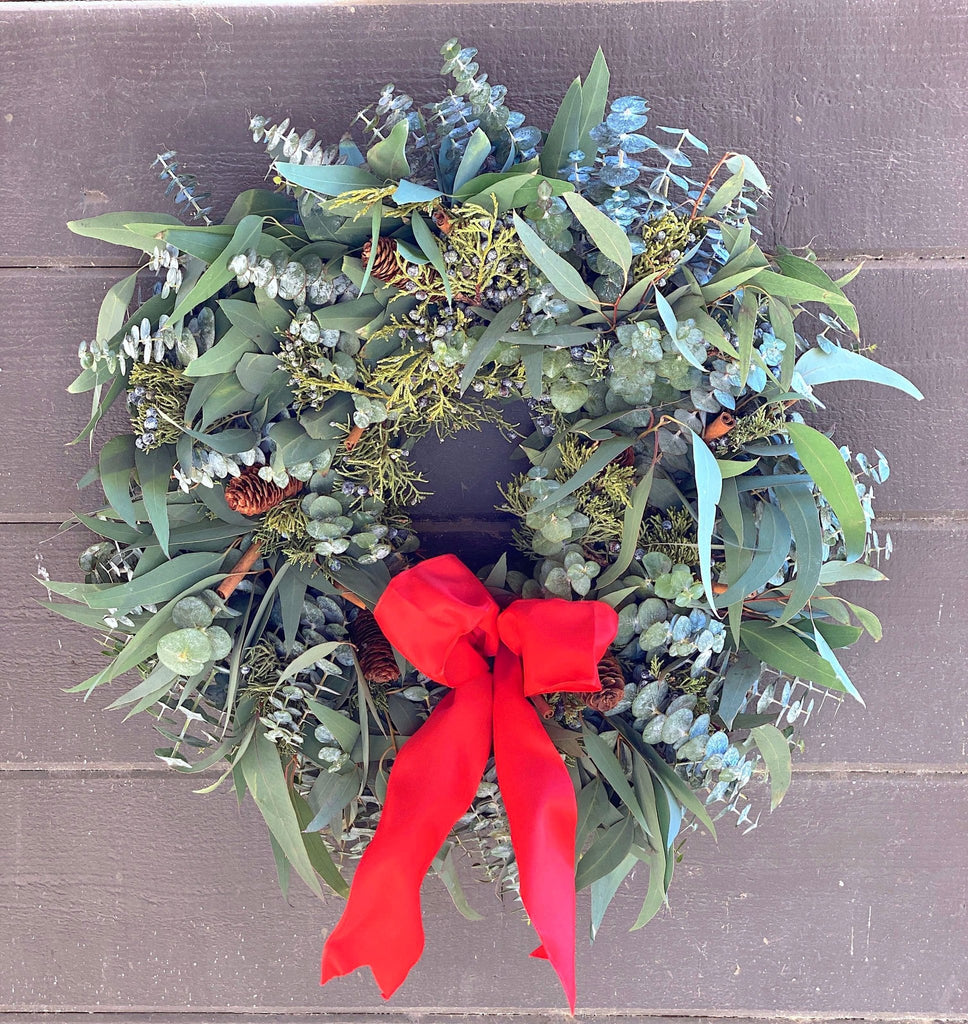 Cinnamon Pine Cone Wreath - Creekside Farms Fragrant eucalyptus, juniper with pine cones, cinnamon sticks & red bow wreath 18"