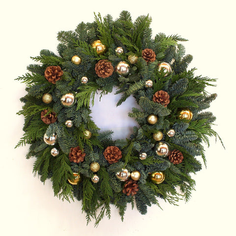 Classic Ornament Wreath - Creekside Farms A unique combination of silver and gold ornaments and pine cones are tucked into a Christmas greens wreath 22"