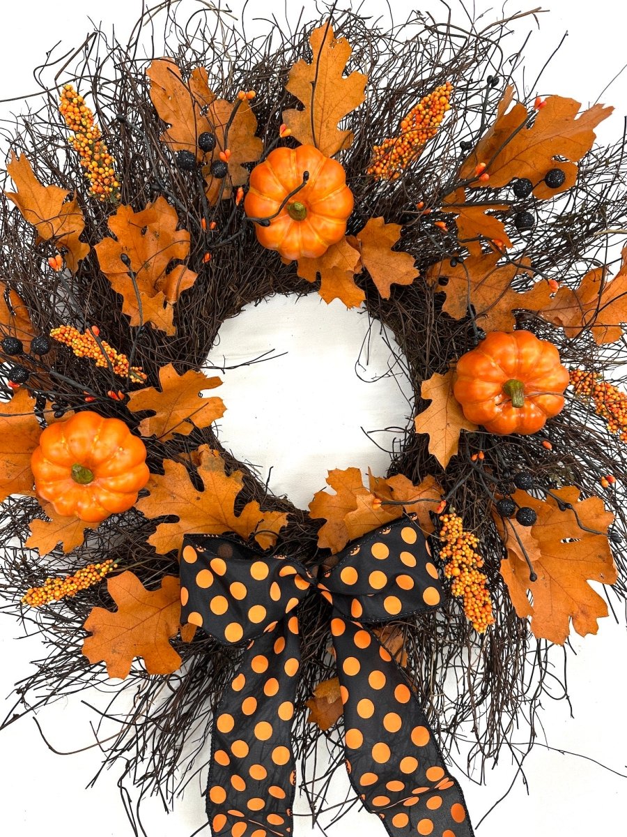 Enchanting Halloween Wreath - Creekside Farms Halloween wreath made with pumpkins, orange and black berries, fall leaves and finished with a bold Halloween ribbon 22"