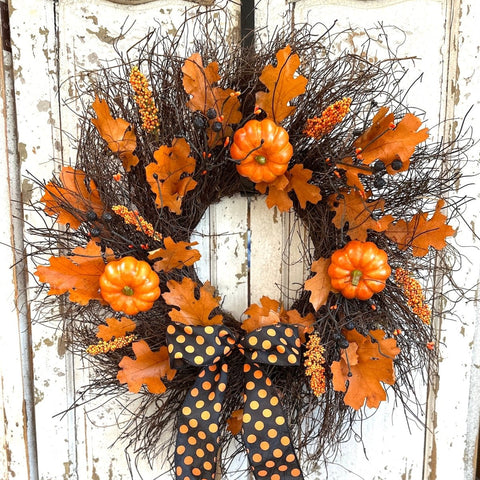 Enchanting Halloween Wreath - Creekside Farms Halloween wreath made with pumpkins, orange and black berries, fall leaves and finished with a bold Halloween ribbon 22"