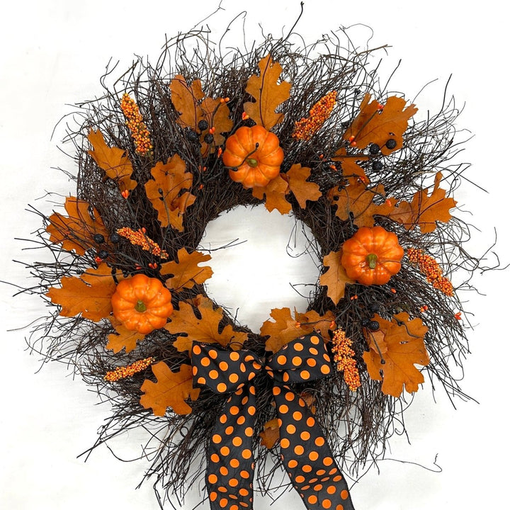 Enchanting Halloween Wreath - Creekside Farms Halloween wreath made with pumpkins, orange and black berries, fall leaves and finished with a bold Halloween ribbon 22"