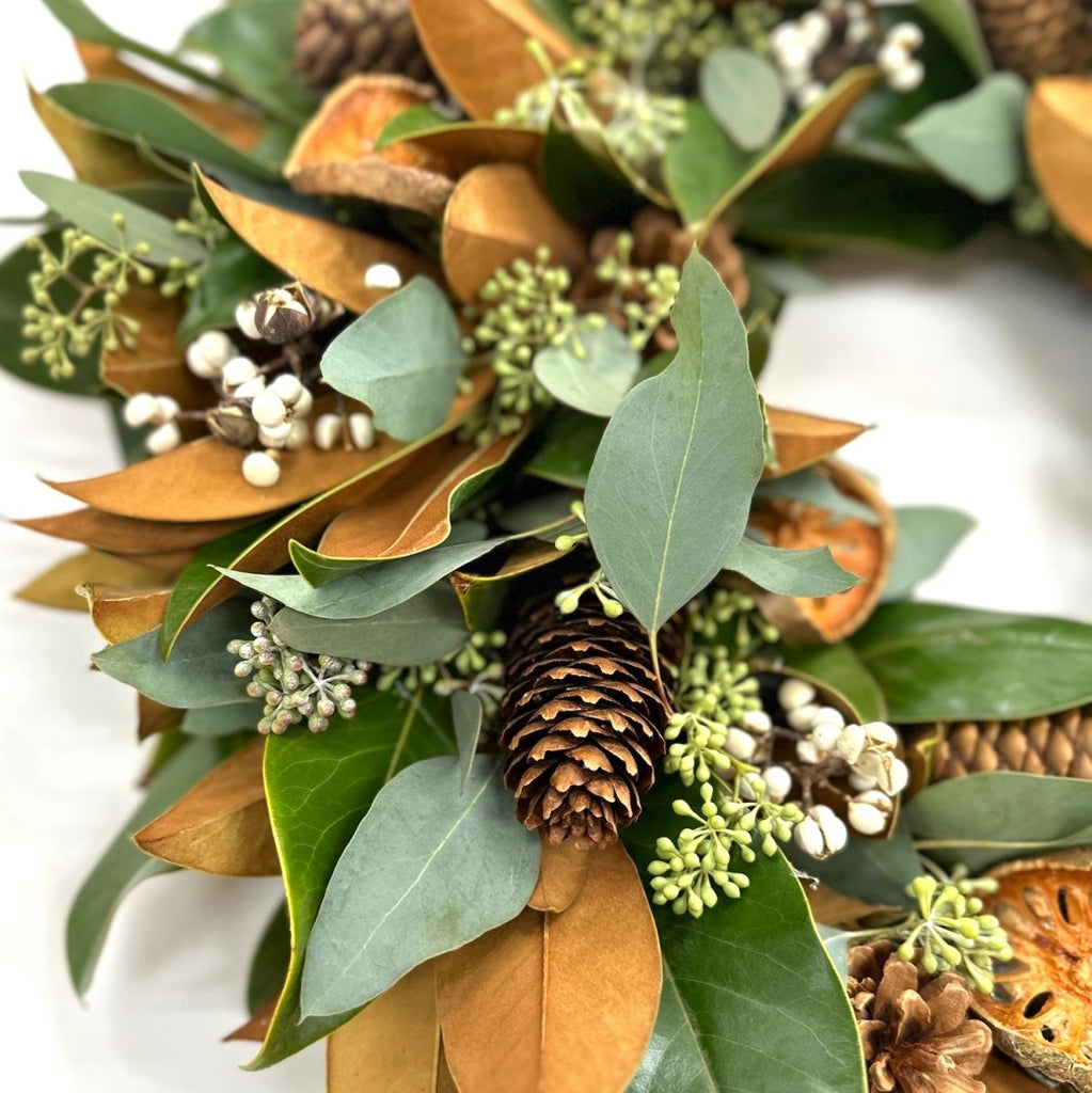 Holiday Magnolia Wreath - Creekside Farms Fresh Magnolia and seeded eucalyptus with orange and white accents wreath 18"/22"