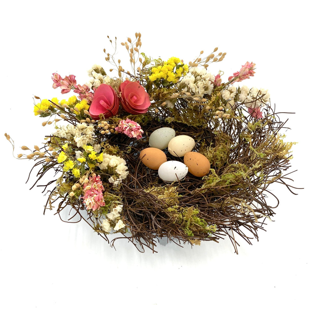 Spring Floral Nest - Creekside Farms Spring flowers and faux eggs adorn a mossy vine nest 10"