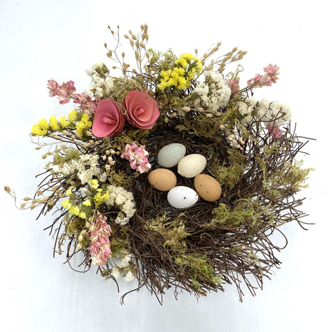 Spring Floral Nest - Creekside Farms Spring flowers and faux eggs adorn a mossy vine nest 10"